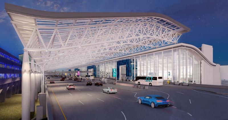 Rendering of upper roadway canopy completion for the terminal lobby expansion, white canopy with traffic on roadway at night time