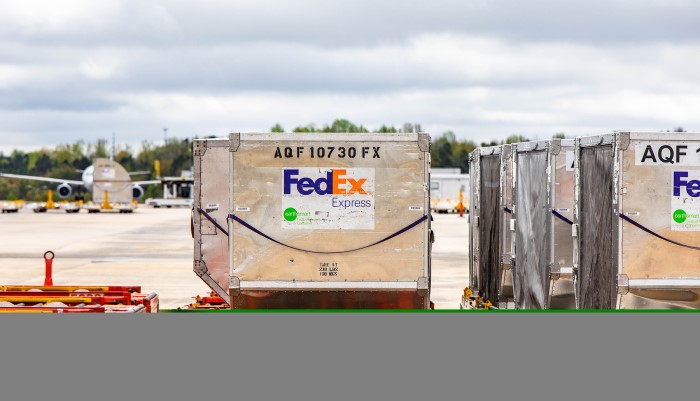 FedEx packaging carriers on airfield 