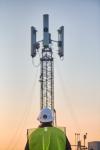 Dish Technician and Tower at Sunset