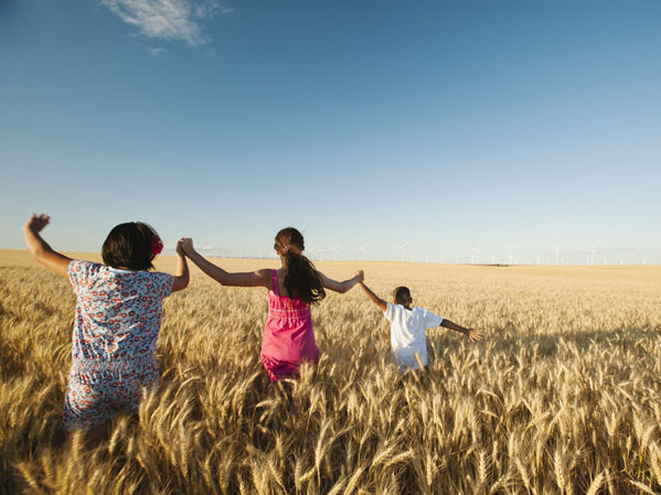 Children running through a wheat field