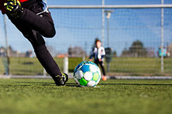 Image of soccer player kicking ball to goal