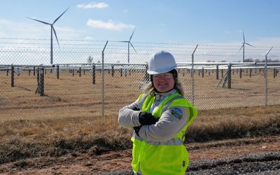 Megan Murphy Salyer in front of wind turbines