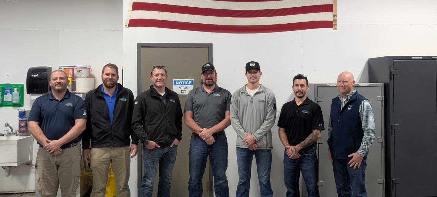 Men standing and smiling 