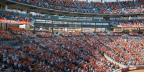 Crowd of fans fills the stands at Oriole Park at Camden Yards during a baseball game, with the Truist Club visible above the seating.
